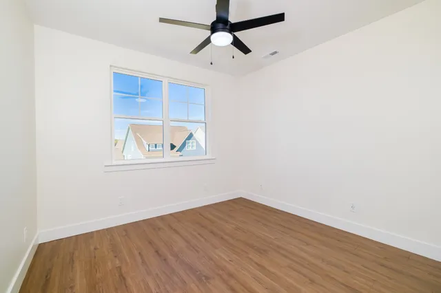 a view of a patio with a table and chairs under an umbrella
