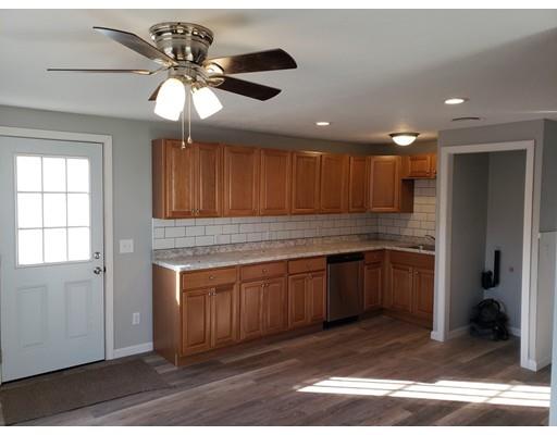 194 Nottingham Street Springfield, MA 01104 - Photo 3 of 13 a kitchen with kitchen island granite countertop wooden cabinets a sink and a stove