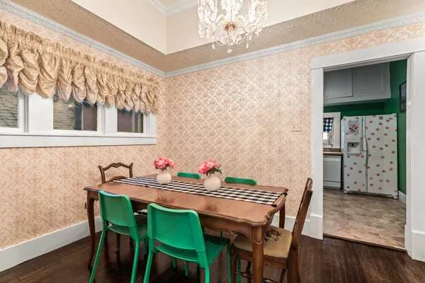 a view of a dining room with furniture and wooden floor