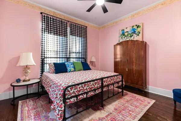 a bedroom with a bed dresser and a window