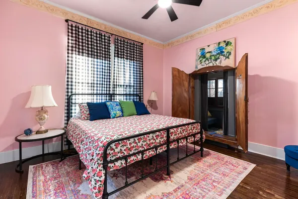 a bedroom with a bed dresser and a window