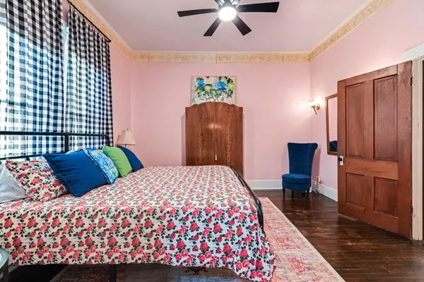 a bedroom with a large bed and a chandelier