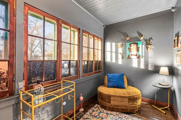 a living room with furniture and a floor to ceiling window