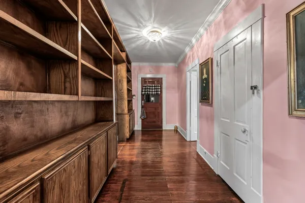 a view of hallway with wooden floor and staircase