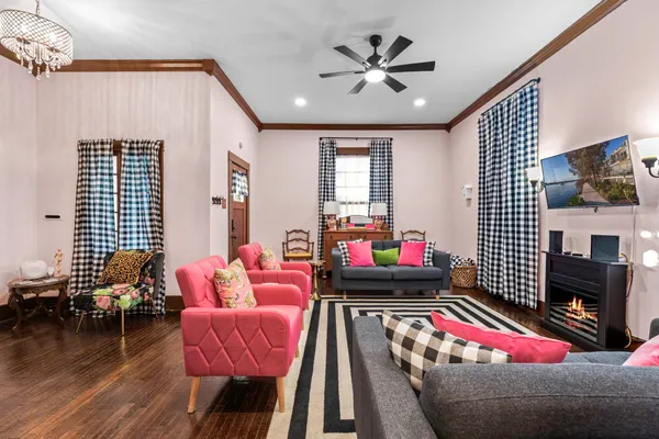 a bedroom with furniture and a flat screen tv
