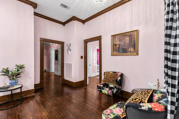 a living room with furniture and wooden floor