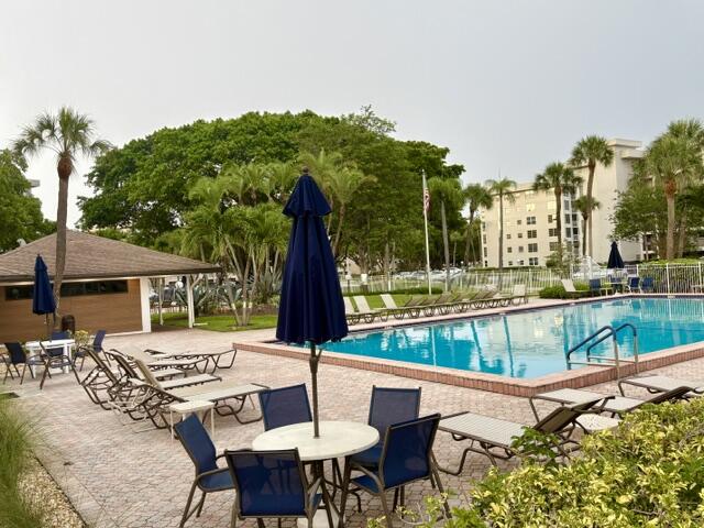 2671 South Course Drive, Unit 108 Pompano Beach, FL 33069 - Photo 22 of 40 a view of a patio with a table chairs and a table and chairs