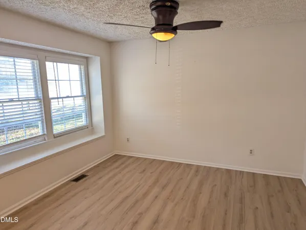 a view of a room with a window and a wooden floor