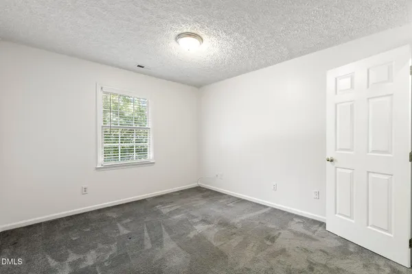 an empty room with a empty space and windows