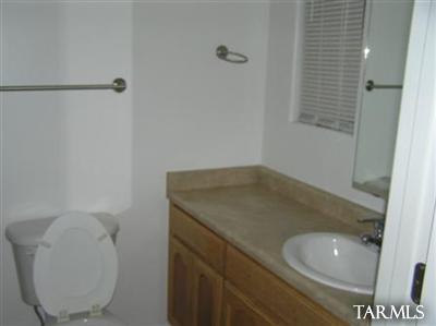 6966 South Radec Lane Tucson, AZ 85756 - Photo 8 of 8 a bathroom with a granite countertop sink and a mirror