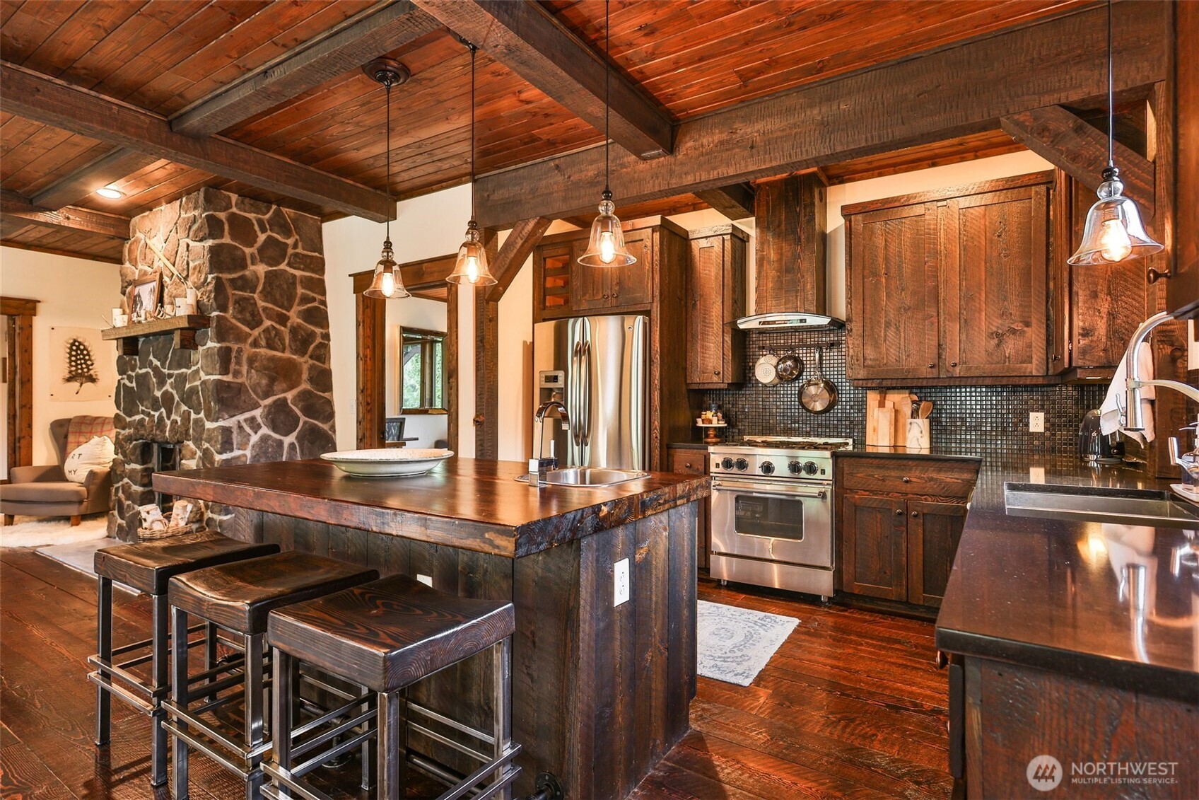 8105 Icicle Road Leavenworth, WA 98826 - Photo 15 of 40 a kitchen with stainless steel appliances granite countertop a stove a sink and a microwave