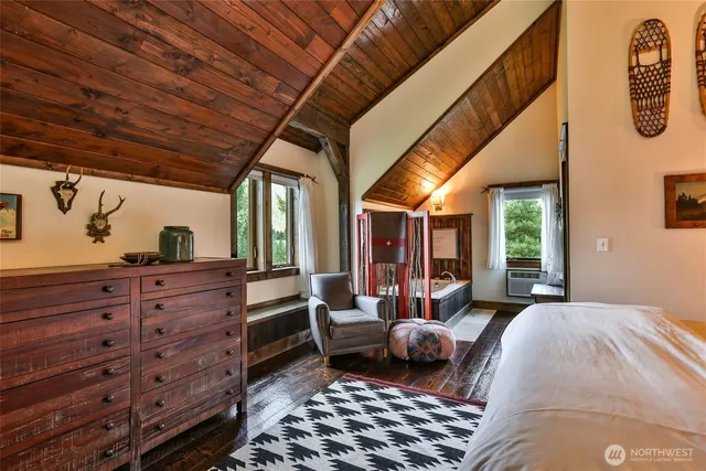 a bedroom with furniture and a large window