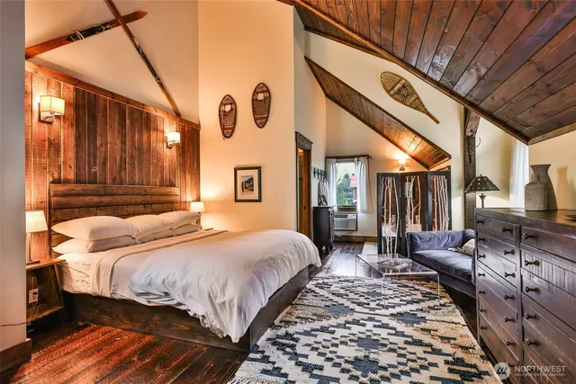 a bedroom with bed and wooden floor