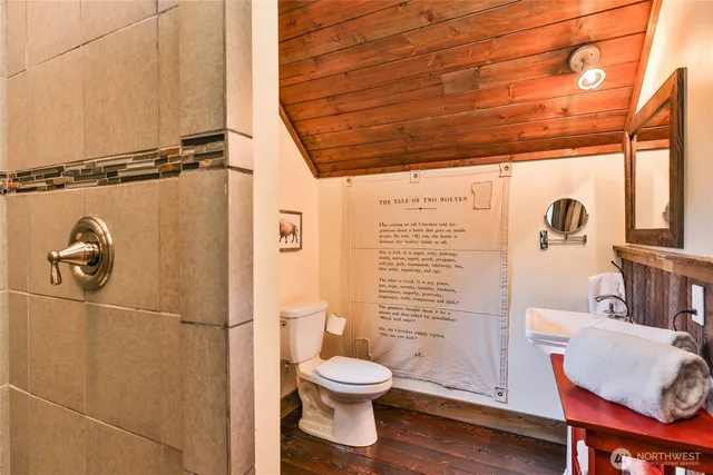 a bathroom with a toilet and a shower