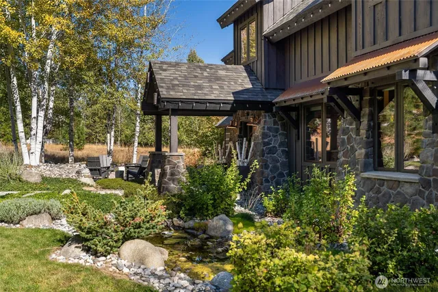 a view of a chair and table of the patio in front of house