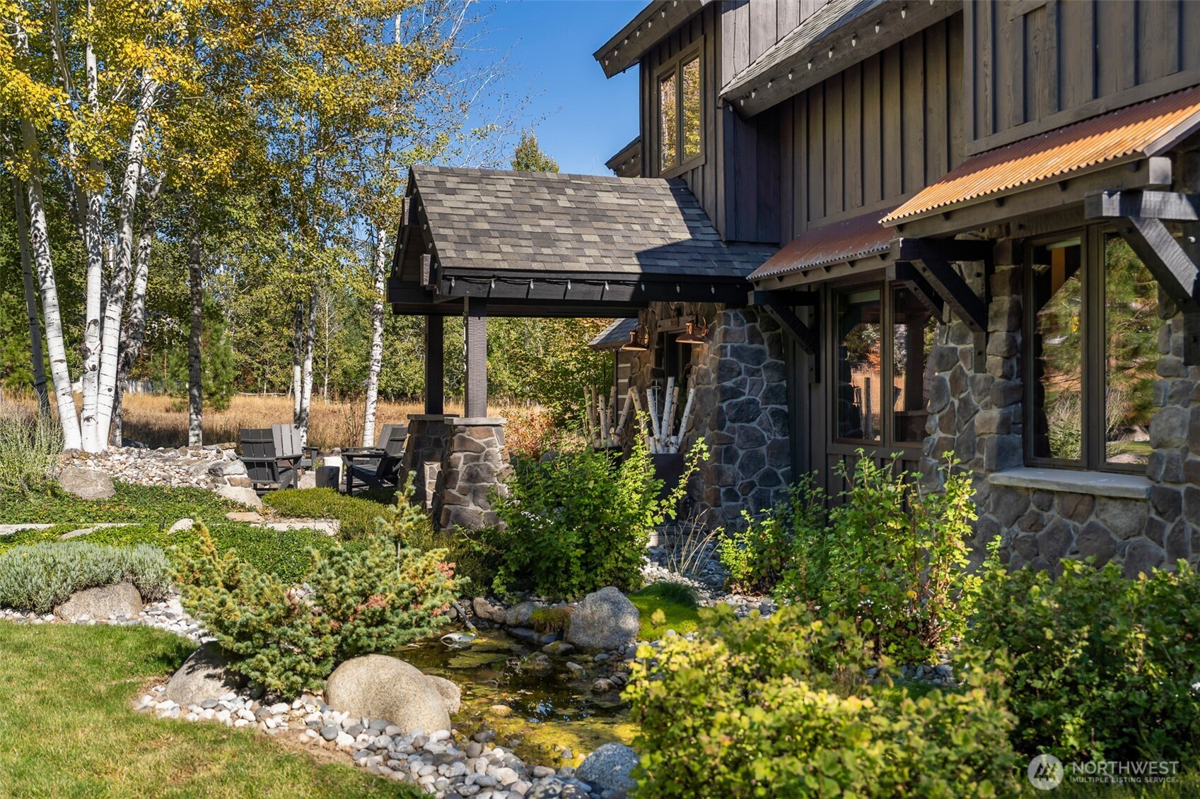 8105 Icicle Road Leavenworth, WA 98826 - Photo 5 of 40 a view of a chair and table of the patio in front of house