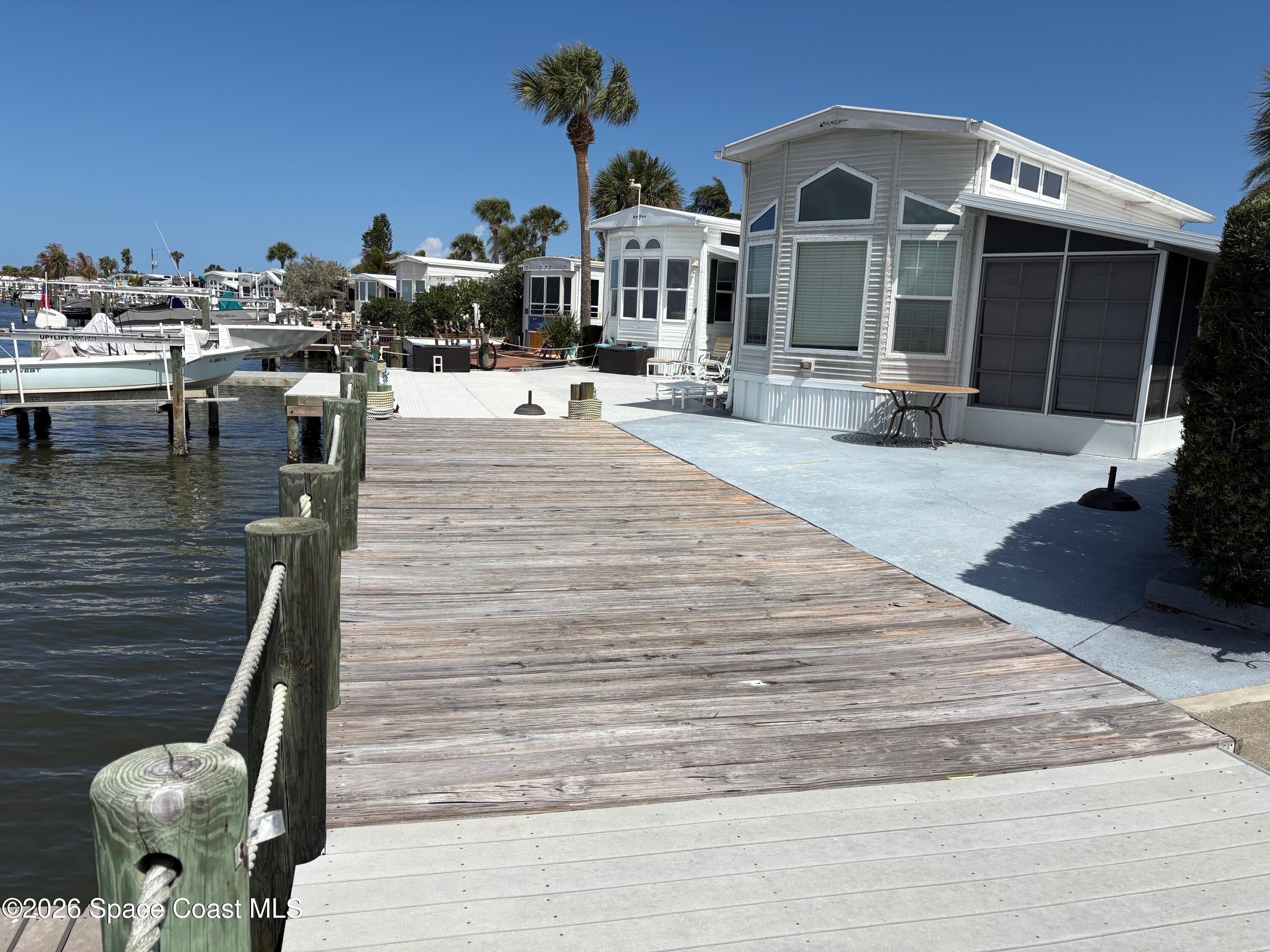 2912 Dockside Lane, Unit 2 Melbourne Beach, FL 32951 - Photo 2 of 66 a front view of a house with outdoor seating