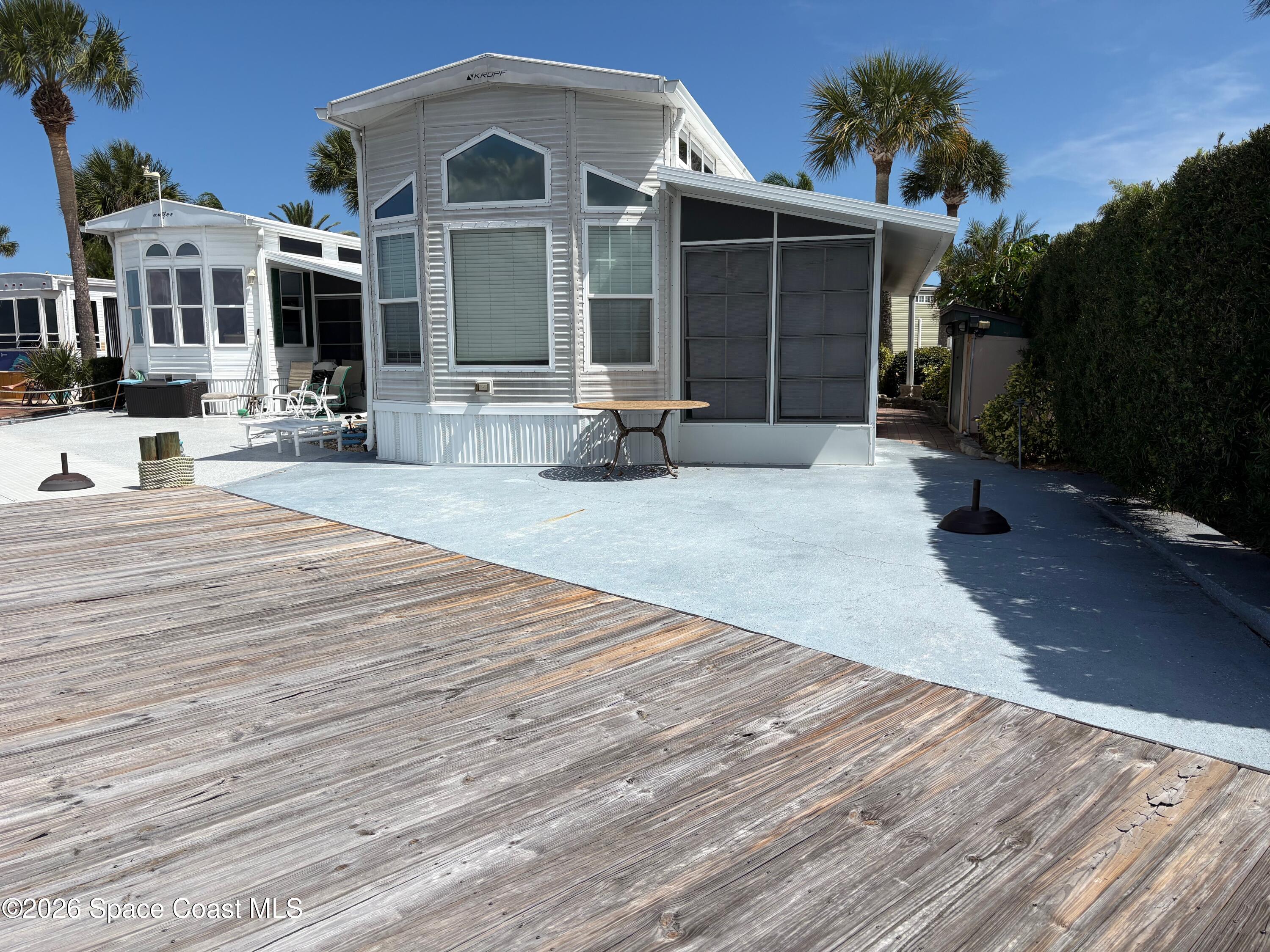 2912 Dockside Lane, Unit 2 Melbourne Beach, FL 32951 - Photo 3 of 66 a front view of a house with yard and green space