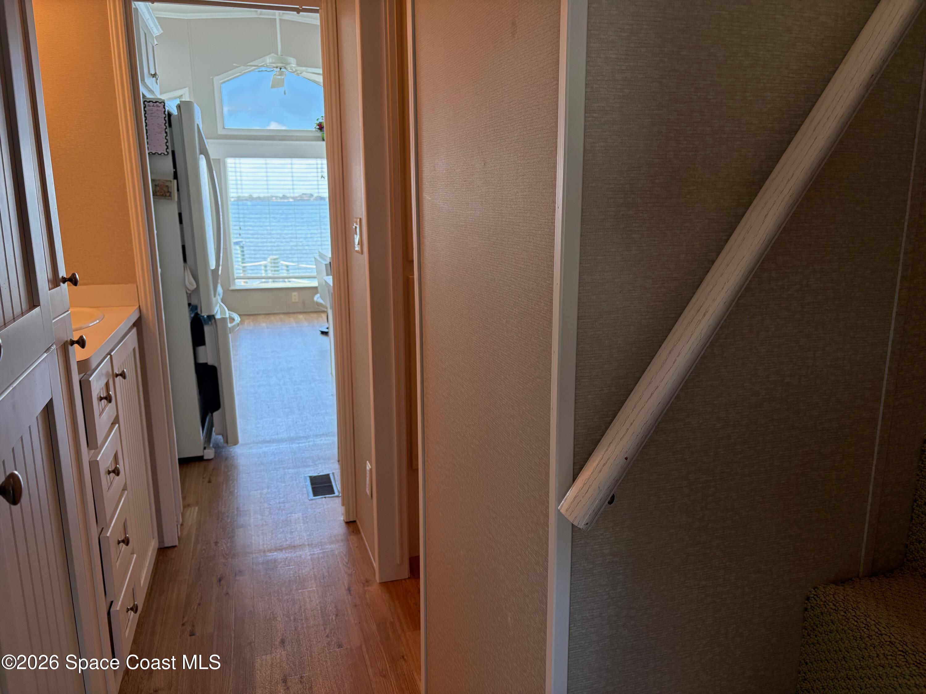 2912 Dockside Lane, Unit 2 Melbourne Beach, FL 32951 - Photo 34 of 66 a view of a hallway with wooden floor and staircase