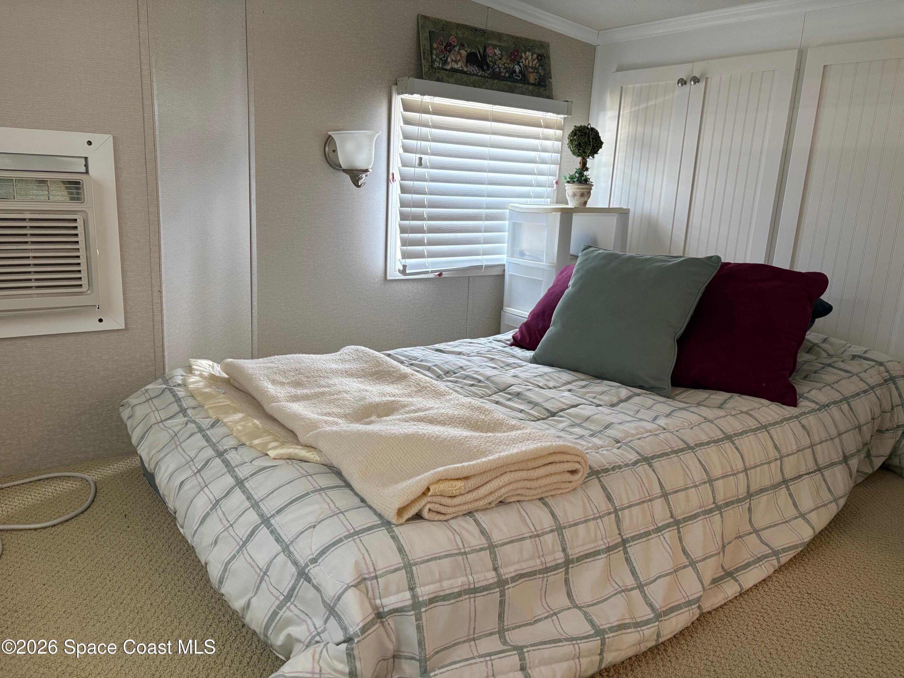 2912 Dockside Lane, Unit 2 Melbourne Beach, FL 32951 - Photo 37 of 66 a bedroom with a bed and a window