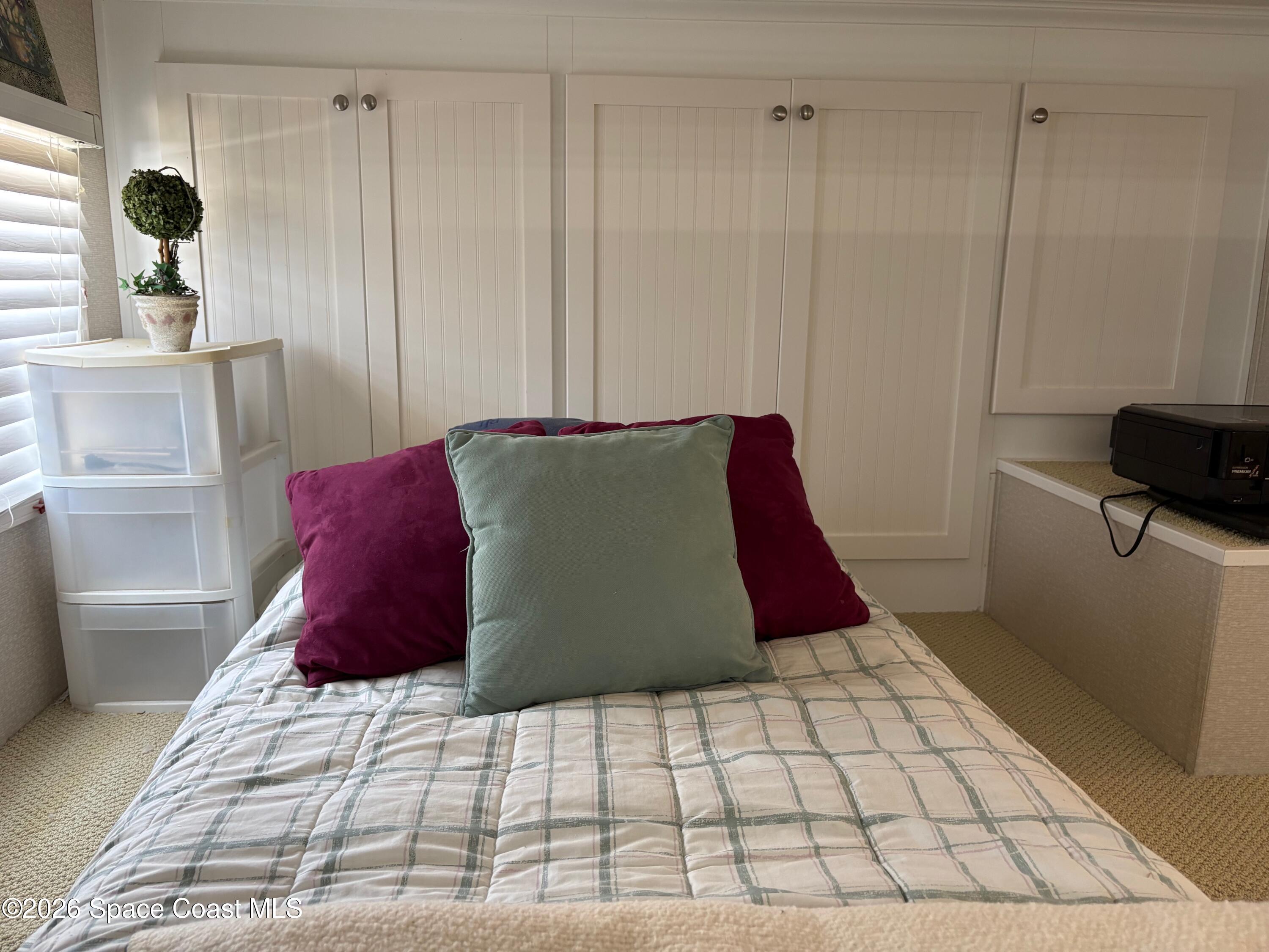 2912 Dockside Lane, Unit 2 Melbourne Beach, FL 32951 - Photo 38 of 66 a large bed sitting in a bedroom next to a window