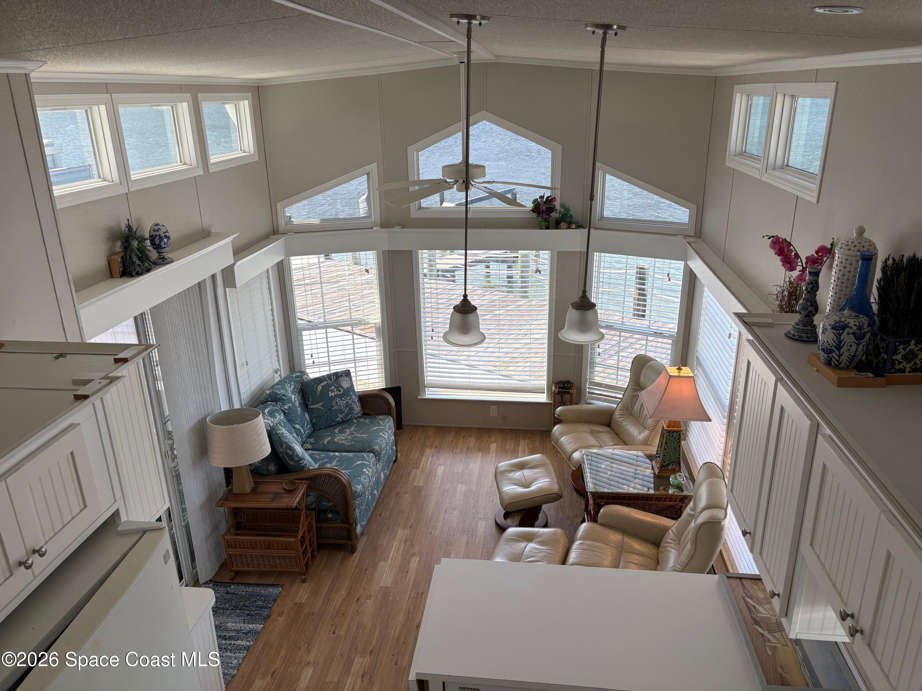 2912 Dockside Lane, Unit 2 Melbourne Beach, FL 32951 - Photo 42 of 66 a living room with furniture and wooden floor