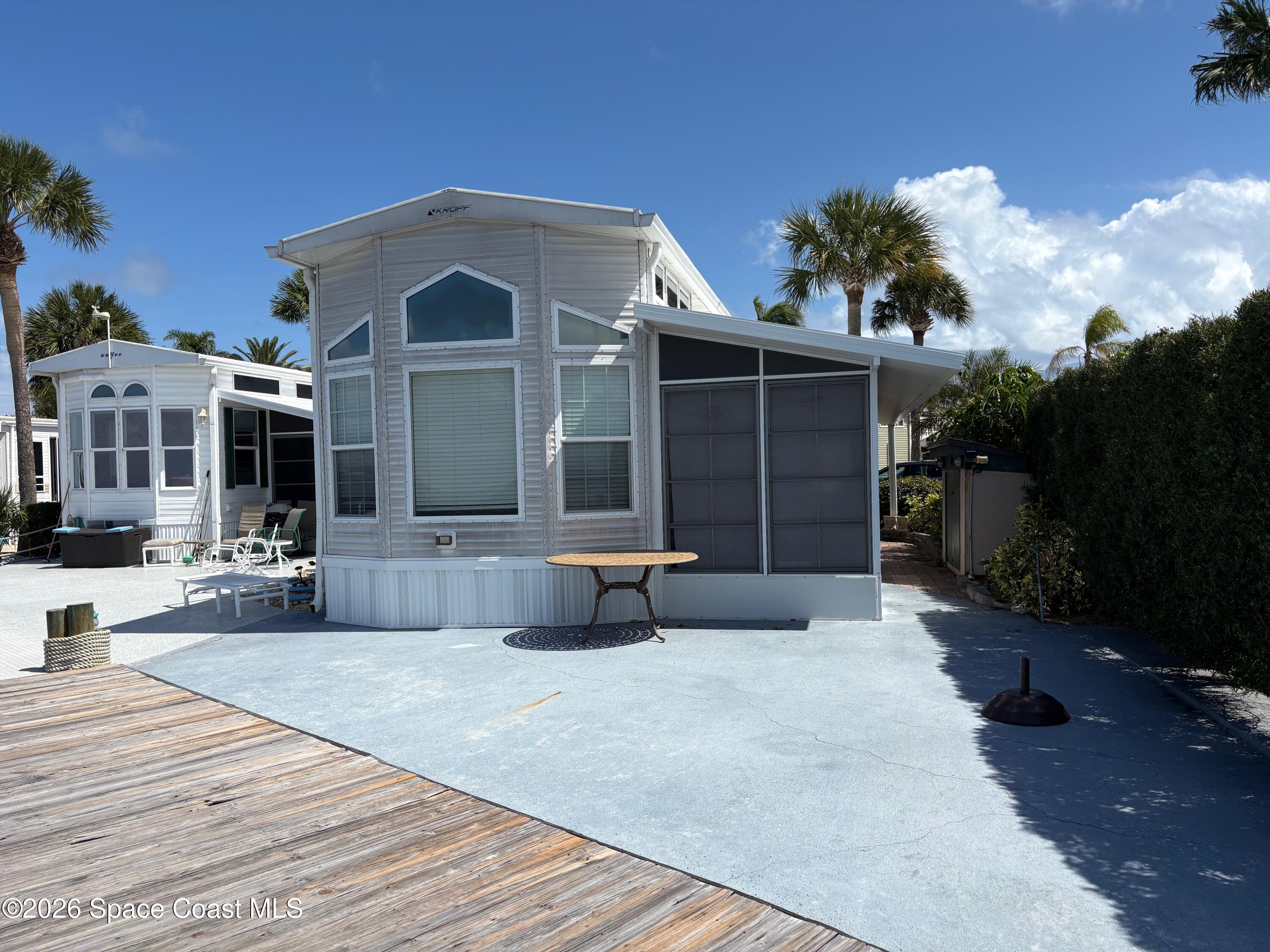 2912 Dockside Lane, Unit 2 Melbourne Beach, FL 32951 - Photo 51 of 66 a front view of a house with a yard