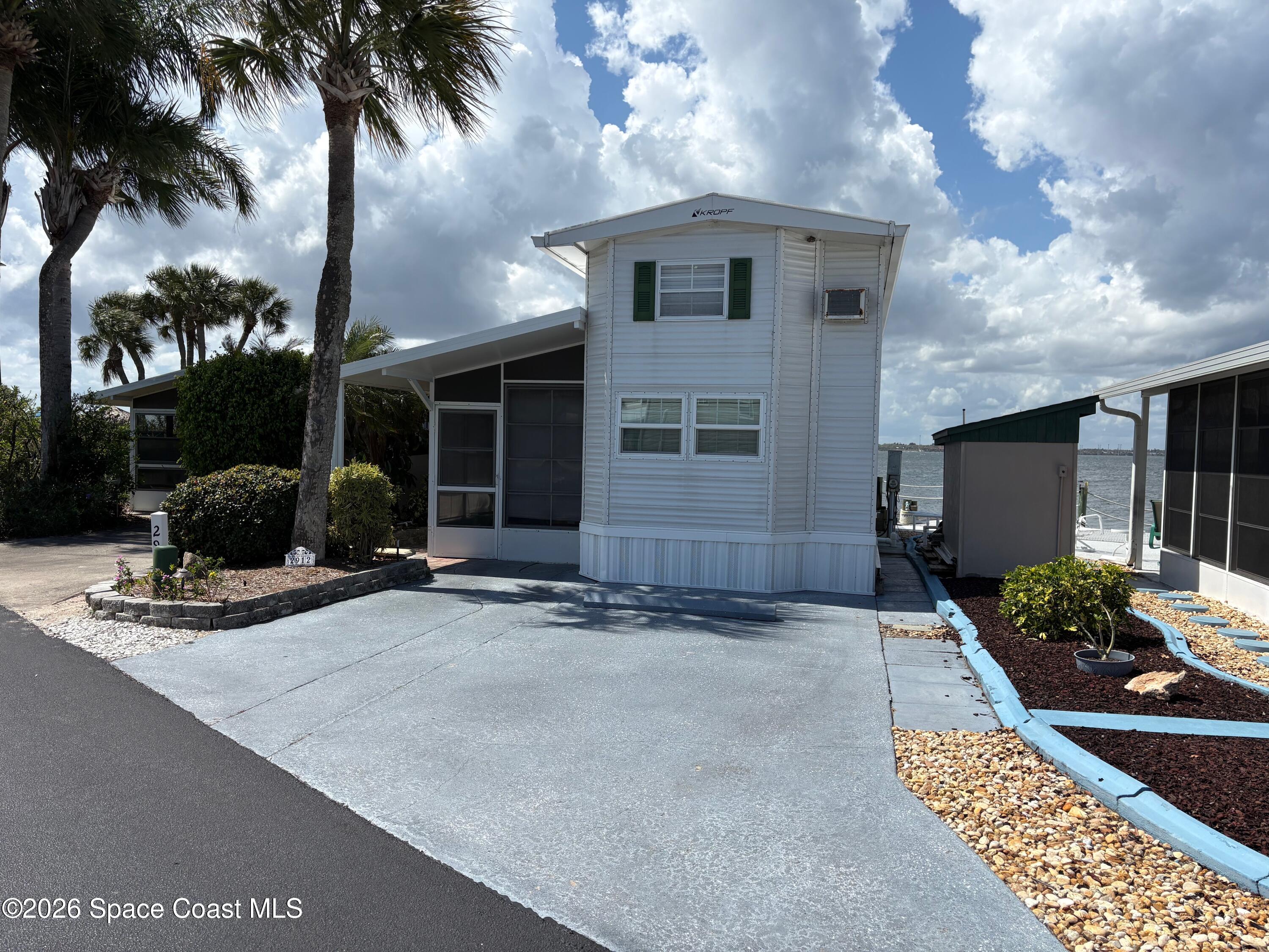 2912 Dockside Lane, Unit 2 Melbourne Beach, FL 32951 - Photo 10 of 66 a view of a house with patio
