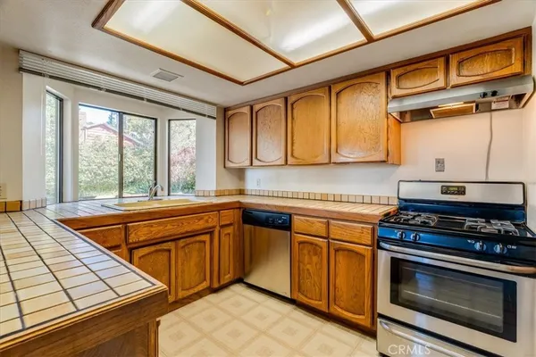 a kitchen with stainless steel appliances granite countertop a stove and a microwave