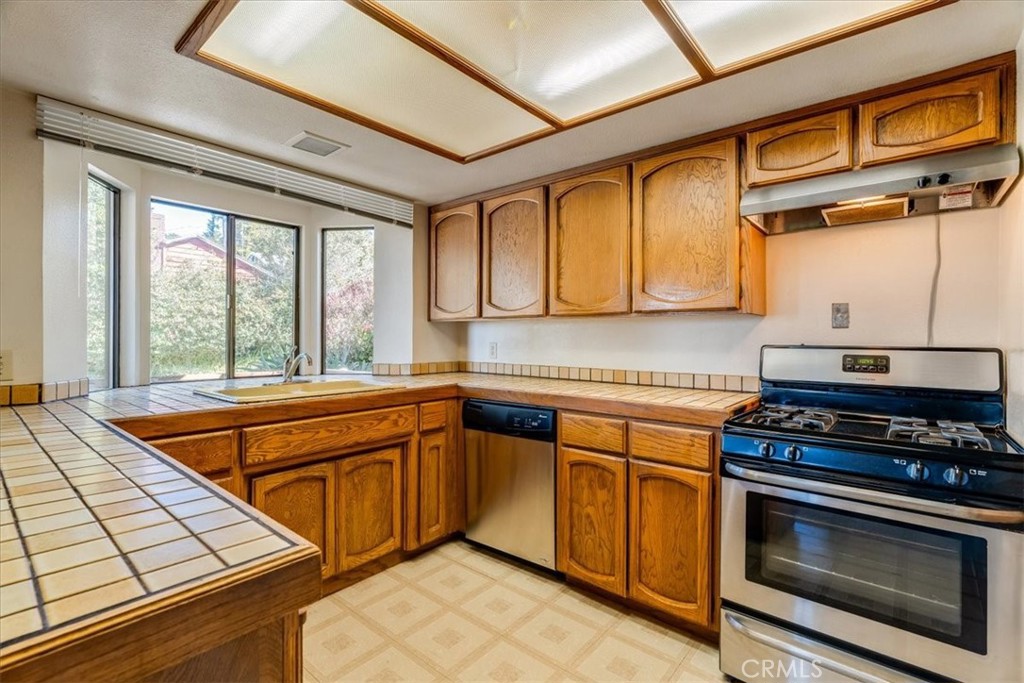 470 Warwick Street Cambria, CA 93428 - Photo 15 of 47 a kitchen with stainless steel appliances granite countertop a stove and a microwave
