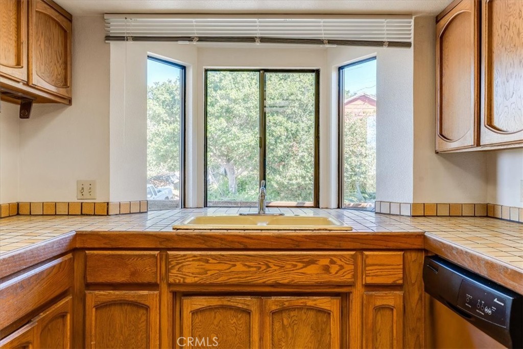 470 Warwick Street Cambria, CA 93428 - Photo 16 of 47 a bathroom with a granite countertop sink and a window
