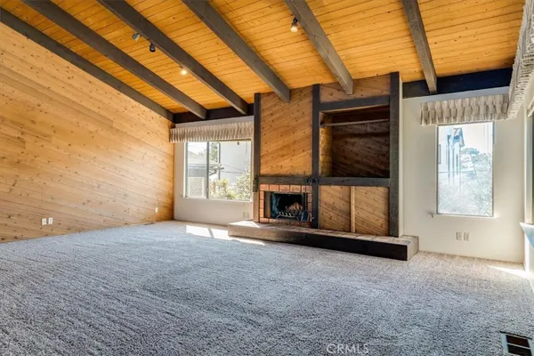 a view of empty room with a fireplace