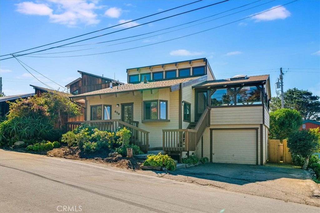 470 Warwick Street Cambria, CA 93428 - Photo 2 of 47 a front view of a house with a garden and plants
