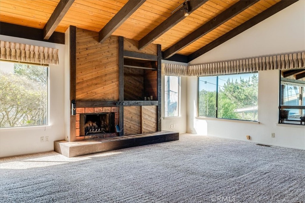 470 Warwick Street Cambria, CA 93428 - Photo 21 of 47 a view of an empty room with a fireplace and a window