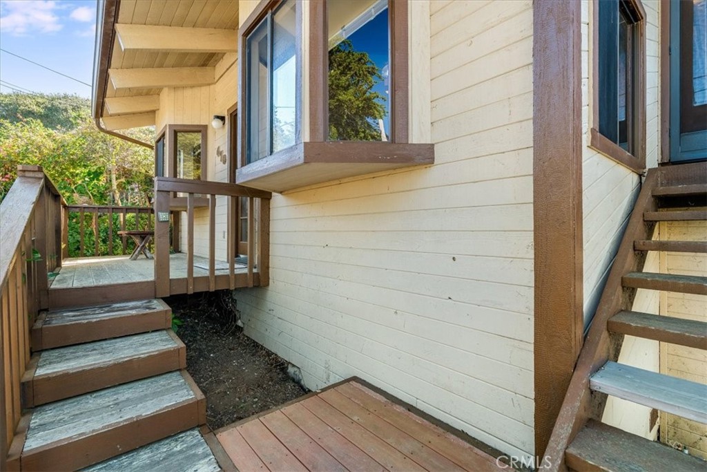 470 Warwick Street Cambria, CA 93428 - Photo 5 of 47 a view of a balcony with wooden floor and stairs