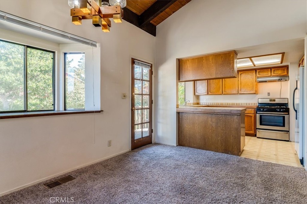 470 Warwick Street Cambria, CA 93428 - Photo 10 of 47 a view of a kitchen with a sink dishwasher and a microwave