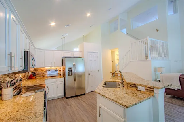 a kitchen with a sink a stove and cabinets
