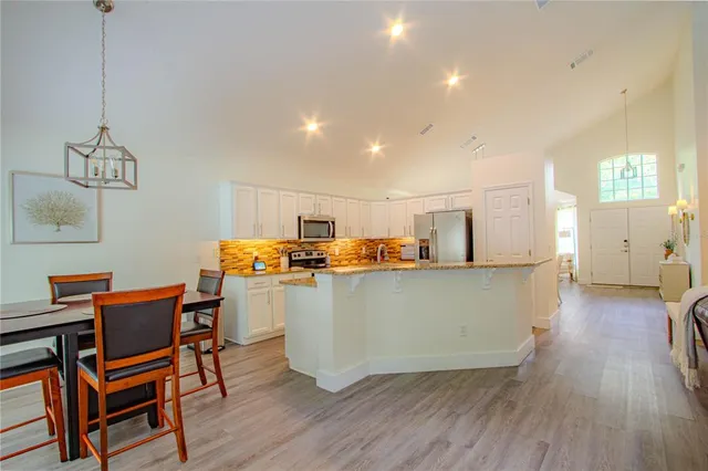 a living room with furniture and large windows