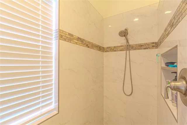 a bathroom with double vanity and a mirror