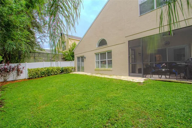 a view of a house with backyard and garden