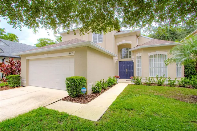 a living room with furniture plant and a window