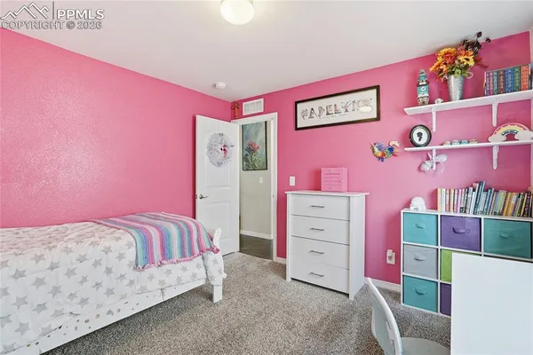 a living room with furniture and a view of kitchen