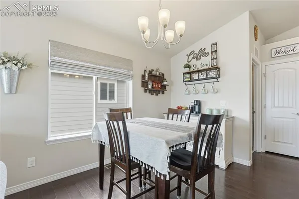 a bed sitting in a spacious bedroom next to a window