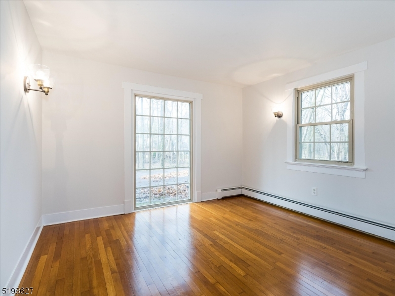 81 Alexander Avenue, Unit 1 Montclair, NJ 07043 - Photo 11 of 15 an empty room with wooden floor and windows