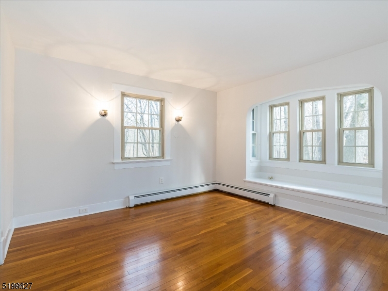 81 Alexander Avenue, Unit 1 Montclair, NJ 07043 - Photo 12 of 15 an empty room with wooden floor and windows