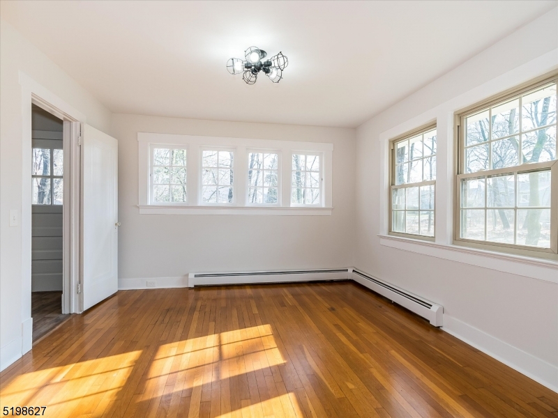 81 Alexander Avenue, Unit 1 Montclair, NJ 07043 - Photo 4 of 15 a view of a room with exposed radiator and windows