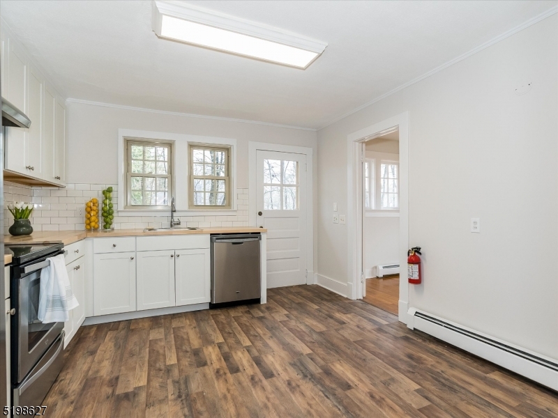 81 Alexander Avenue, Unit 1 Montclair, NJ 07043 - Photo 6 of 15 a kitchen with a sink cabinets and wooden floor
