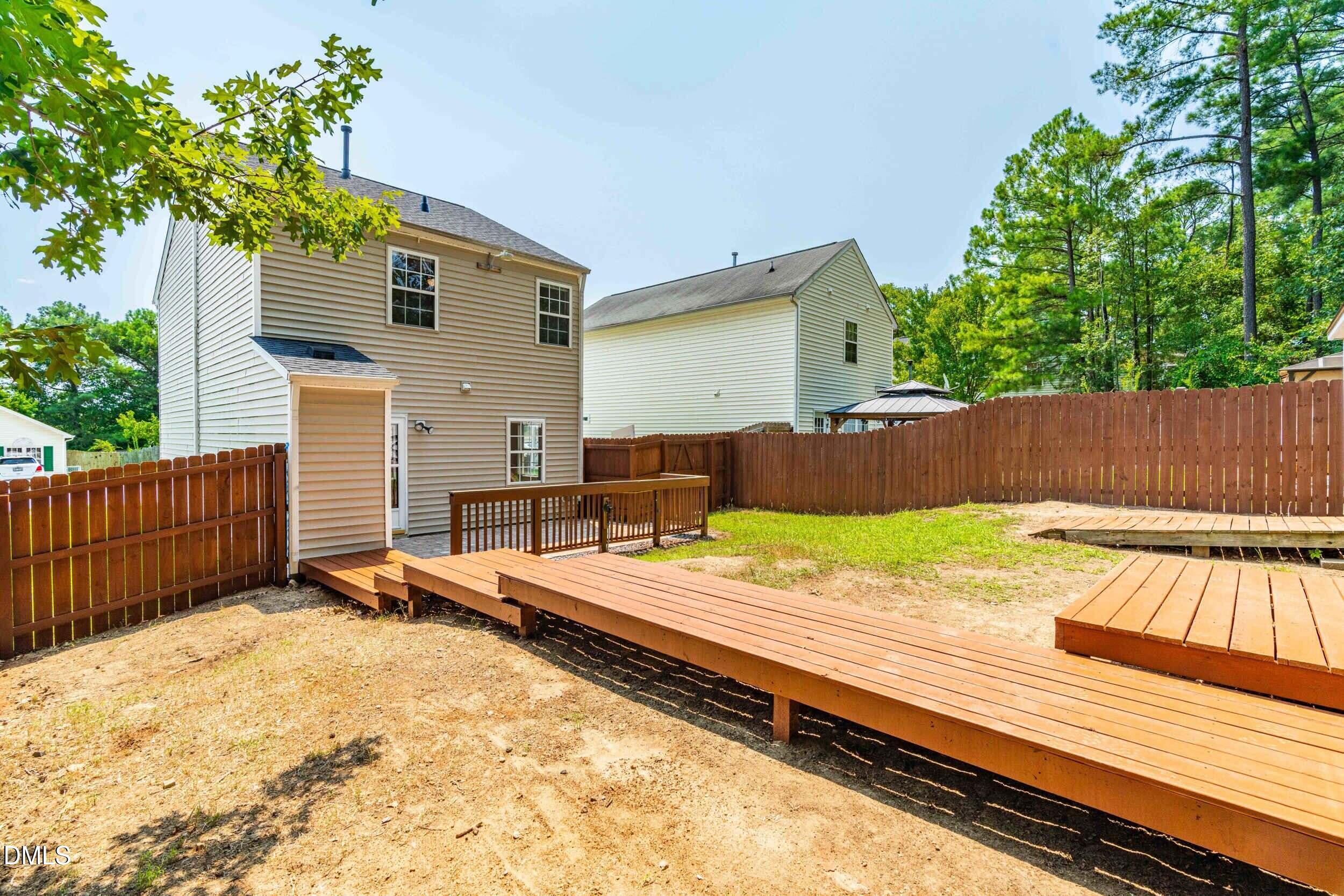 4121 Tensity Drive Raleigh, NC 27604 - Photo 26 of 34 Rear exterior with deck and fully fenced yard