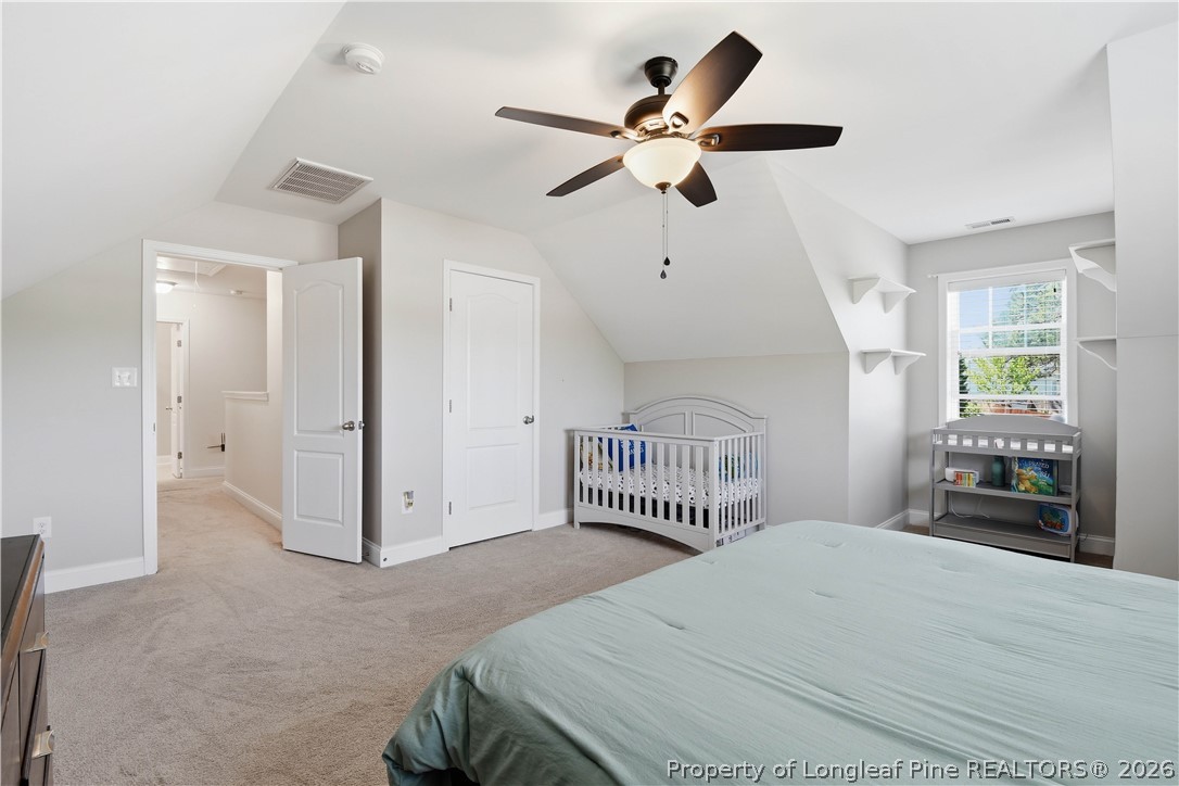 140 Birch Avenue Spring Lake, NC 28390 - Photo 41 of 49 a bedroom with a large bed and a chandelier