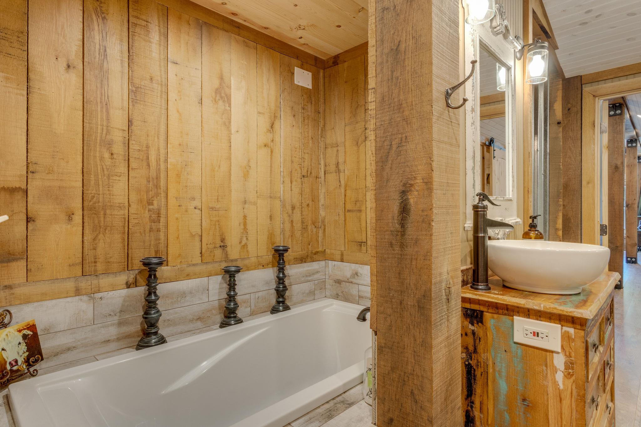 3920 Boston Theta Road Columbia, TN 38401 - Photo 11 of 30 a bathroom with a tub a sink and a mirror